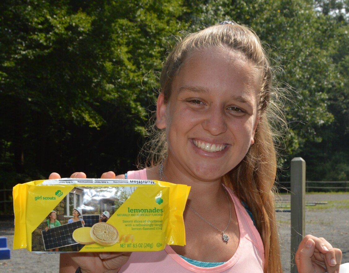 Earlham College sophomore Serena Pisacano holds a package of Girl Scout cookies featuring her image.